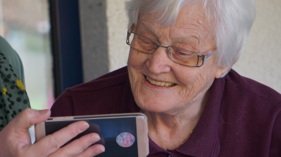 Older woman viewing something on a mobile phone